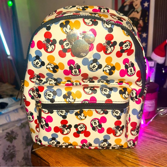 Bioworld Handbags - Disney Mickey Mouse Multi color Monogram all around mini Backpack by Bioworld.